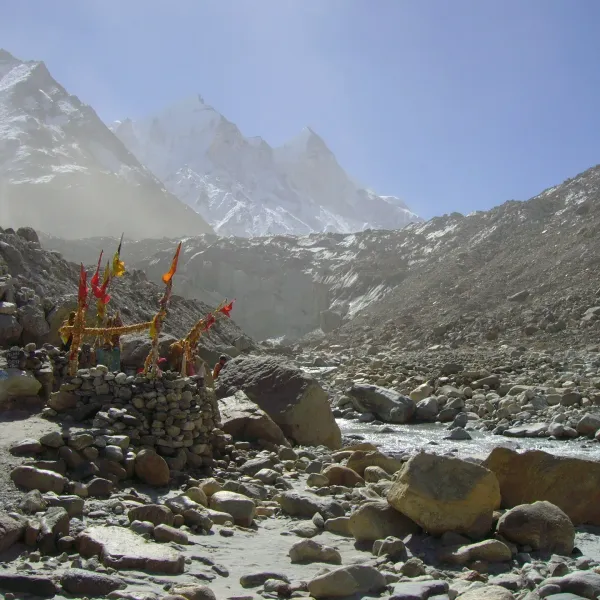 A small shrine with colourful flags at Gaumukh, the snout of the Gangotri Glacier, with the Bhagirathi peaks behind