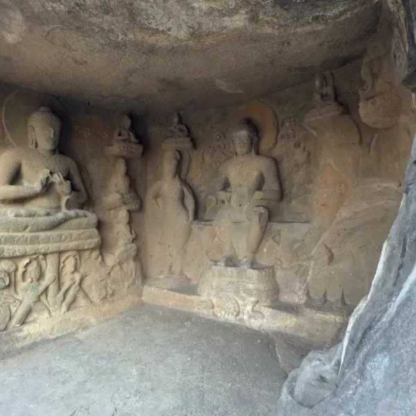 Carved Buddha figures in a rock niche at the Pandavleni caves