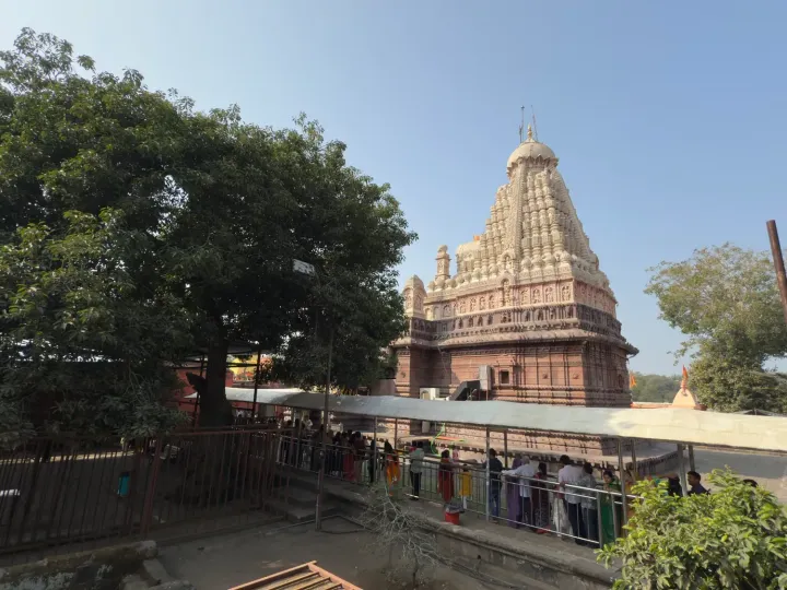 The carved spire of the Grishneshwar Jyotirlinga temple above the queue of pilgrims