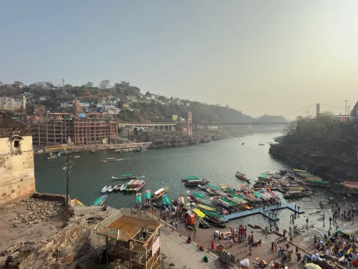 The Narmada at Omkareshwar with boats, ghats and the temple on the island